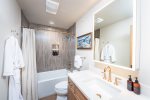 With modern fixtures and amenities, the bathroom is a spa-like retreat.